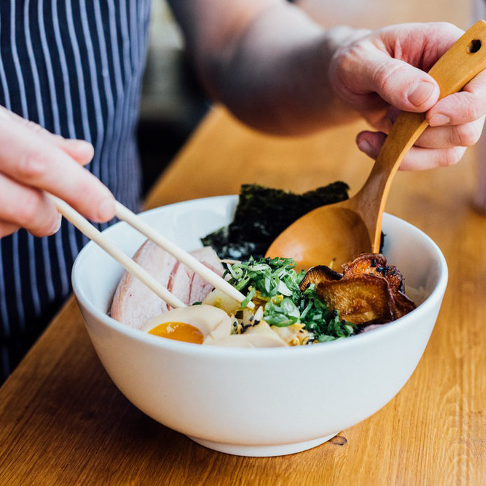 Digging into a beautifully presented bowl of ramen